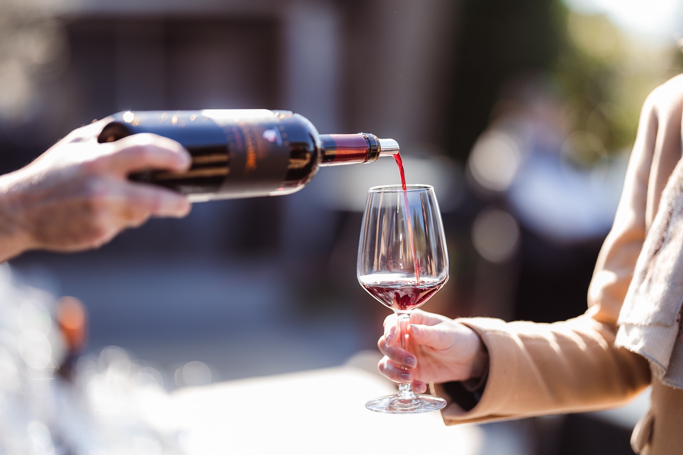 Wine being poured in golden light at the seaside lounge